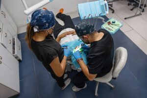 Top,View,Of,Dentist,And,Assistant,Performing,Treatment,In,A